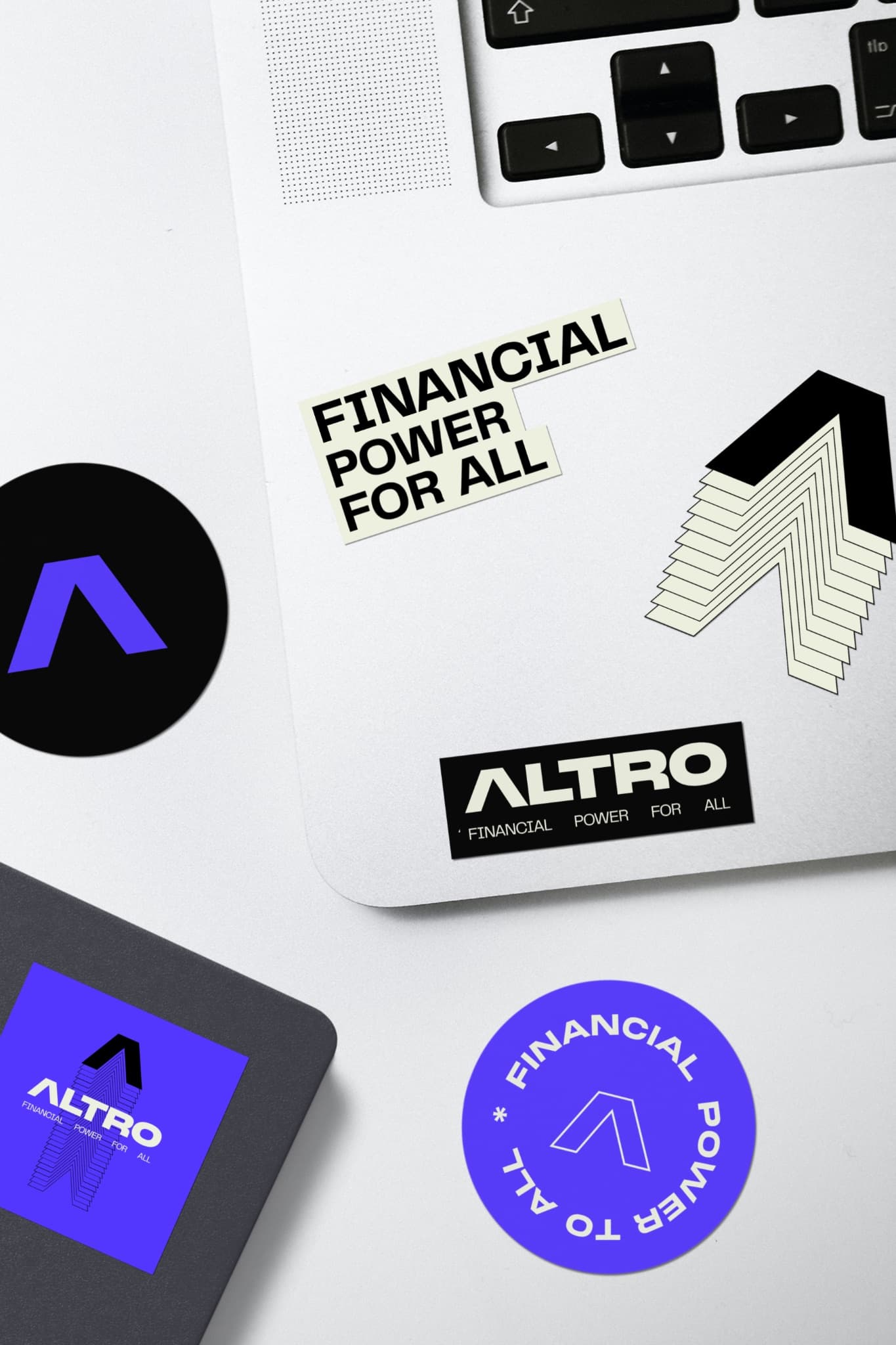 Altro stickers on a laptop and notebook: “Financial power for all”